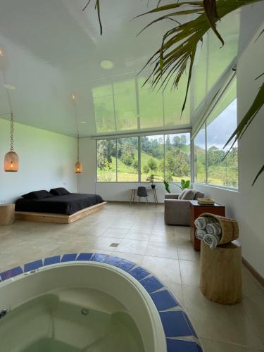 a large living room with a tub in the middle at El Rancho de Salento in Salento