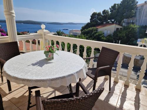 a white table and chairs on a balcony at Apartmens Špiko 2 in Hvar