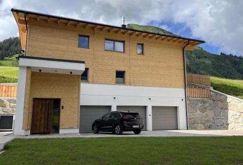 a car parked in front of a house at Quartier Severin in Berwang
