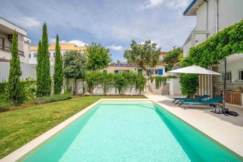 Πισίνα στο ή κοντά στο GuestReady - Casa do Jacarandá