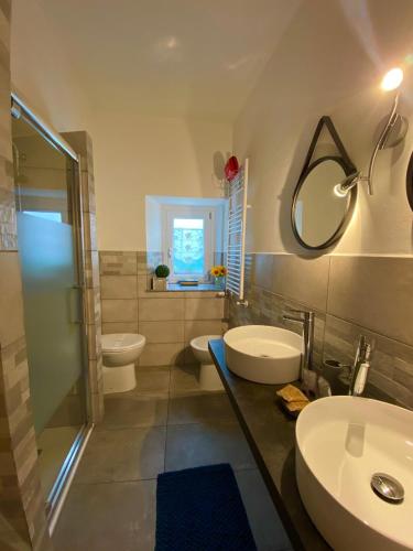 a bathroom with two sinks and a shower and two toilets at Cà Di Toni in Testana