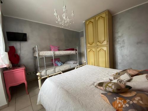 a bedroom with a bed and a chandelier at Cà Di Toni in Testana