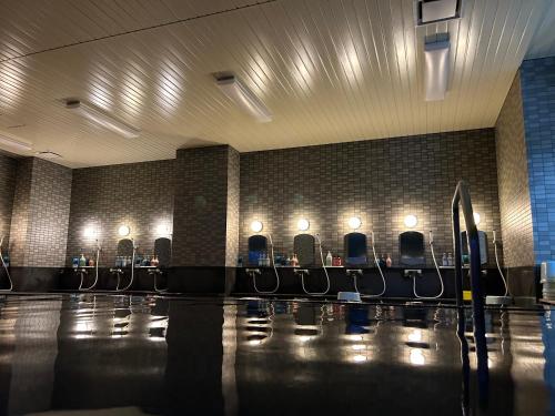 a row of chairs in a room with lights at Asakusa Sanso in Uonuma