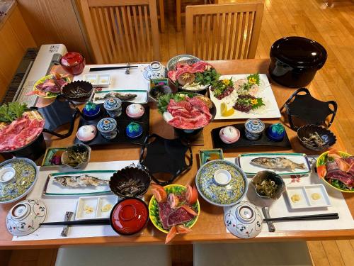 a table with a bunch of plates of food at Asakusa Sanso in Uonuma
