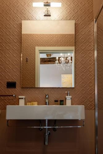 a bathroom with a sink and a mirror at Neoclassico by Tiziana Monaldi in Pitigliano