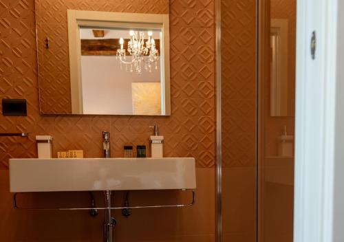a bathroom with a sink and a mirror at Neoclassico by Tiziana Monaldi in Pitigliano