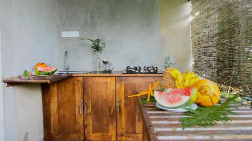 a kitchen with a counter with fruits on it at Eco Breeze - Unawatuna in Unawatuna