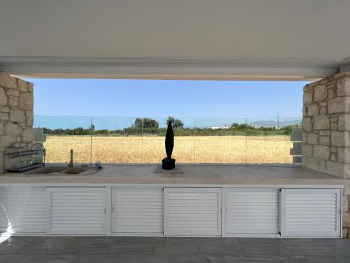 a kitchen with a window with a statue in the middle at First Eco-Villa in Polis Chrysochous