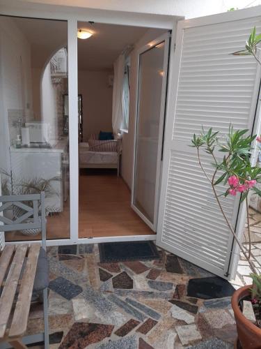 a sliding glass door leading to a living room at Apartments Vila Miranda on the beach in Barbat na Rabu