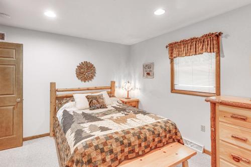 a bedroom with a bed and a dresser and a window at Pennsylvania Cabin Hideaway Hot Tub and Deck! in Belleville