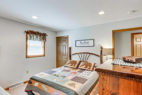 a bedroom with a bed and a wooden dresser at Pennsylvania Cabin Hideaway Hot Tub and Deck! in Belleville