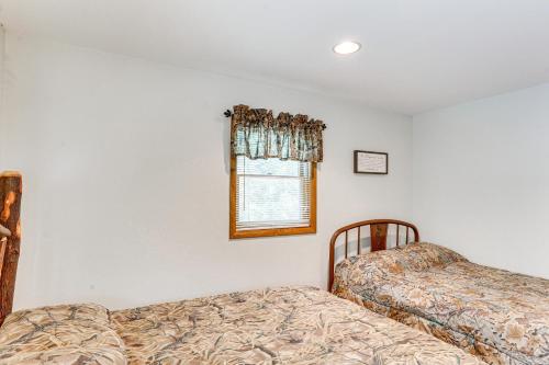 a bedroom with two beds and a window at Pennsylvania Cabin Hideaway Hot Tub and Deck! in Belleville