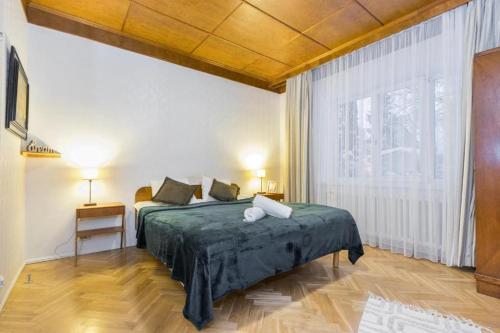 a bedroom with a bed and a large window at Villa Ernesaks - Private yard and grill in Tallinn