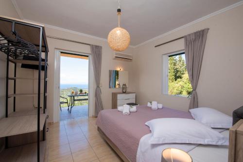 a bedroom with a bed and a balcony at Agnantio in Agios Nikitas