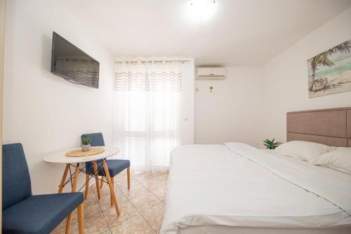 a bedroom with a bed and a table and chairs at Villa Dana in Bar