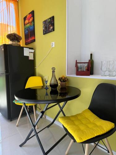 a dining room with a table and two chairs at Guest house Me and grandfather-მე და პაპა in Dedoplis Tskaro