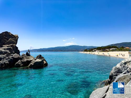 a view of a beach with a mountain in the background at CALALUNGA PIETRAGRANDE - Exclusive Shoreline Haven in Montepaone Lido