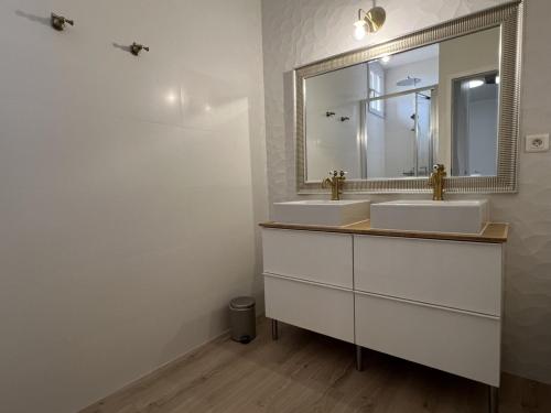 a bathroom with two sinks and a mirror at La Millière - Piscine & campagne - Bonchamps in Le Poiré-sur-Vie
