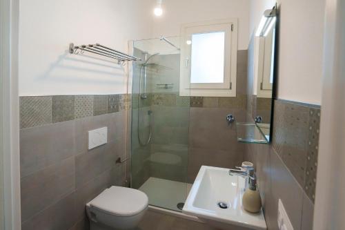 a bathroom with a shower and a toilet and a sink at Seaview in Torre Grande