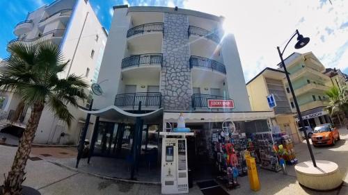 a building with a gas pump in front of it at Residence Le Vele in Cattolica