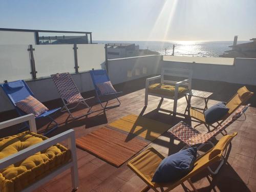 a group of chairs and tables on a cruise ship at House Moledo sea view in Moledo