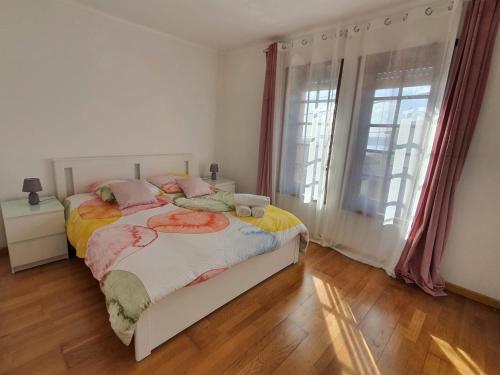a bedroom with a bed and a window at House Moledo sea view in Moledo