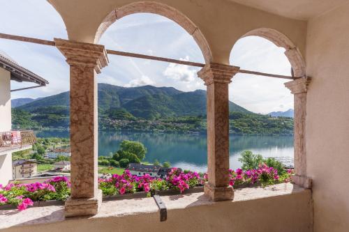 a window with a view of a lake and mountains at Appartamenti VERDE ACQUA in Pergine Valsugana