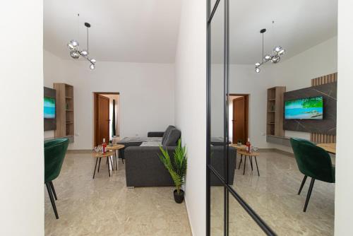 a living room with green chairs and a couch at Villa Dana in Bar