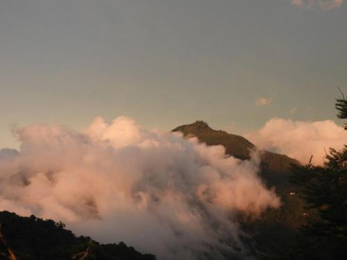a view of a mountain with clouds on it at hotel y restaurante mirador aires de la sierra, minca in Minca