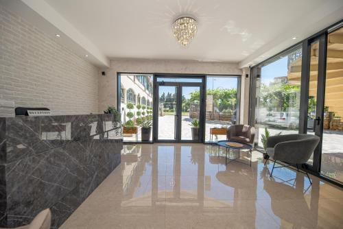 a lobby with two chairs and a table and windows at Villa Dana in Bar