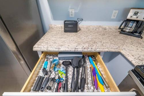 a drawer filled with tools on top of a counter at Charming and delightful getaway! Walk to Beach in Saint Augustine