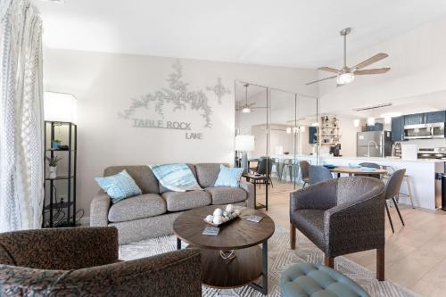 a living room with a couch and chairs and a table at Oasis on Table Rock Lake in Kimberling City