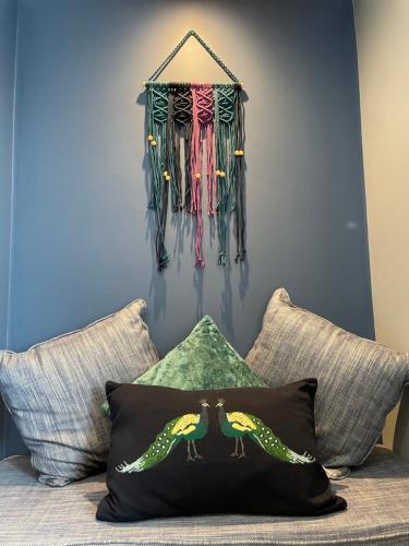a room with a wall with umbrellas hanging on the wall at The Ship Inn's Mill Cottage - Weavers Way in Gatehouse of Fleet