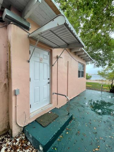 a garage with a white door and a roof at Kings Kamp in Key Largo