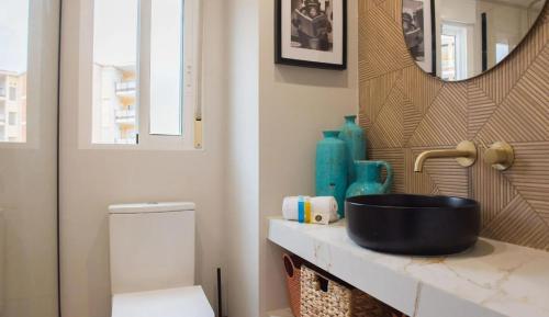a bathroom with a sink and a toilet at La Casita Bonita - 30m from the Arenal Beach - Private Parking in Jávea