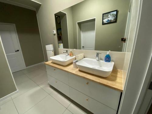 a bathroom with two sinks and a large mirror at Mickey central hostel in Ulaanbaatar
