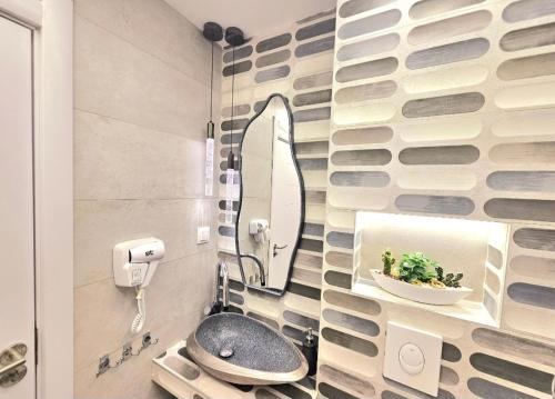 a bathroom with a mirror and a sink at SUN SEA No 7 first line in Perea