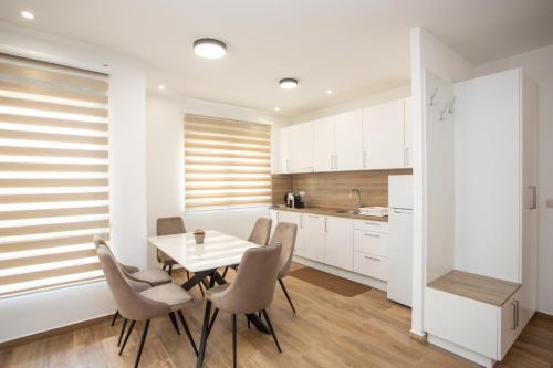 a kitchen and dining room with a table and chairs at Apartments NIKOS FAMILY in Ulcinj