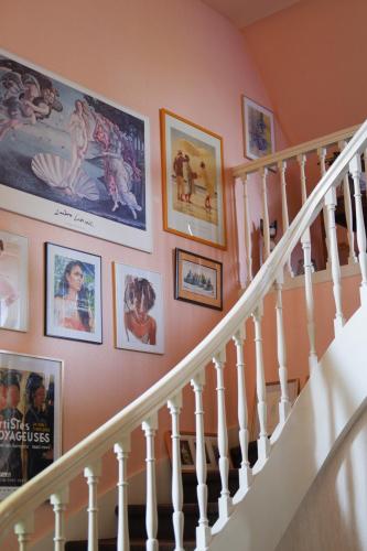 a staircase with pictures on the wall at La Chambre d'Agapè in Fouesnant