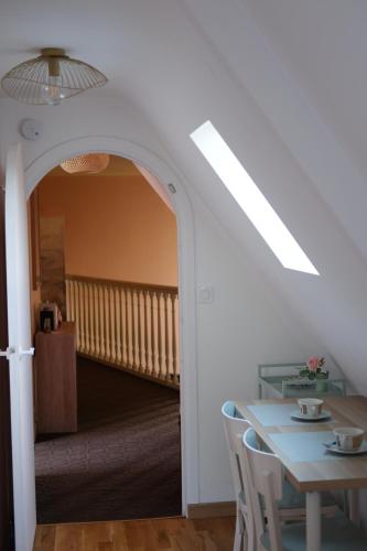 a dining room with a table and a staircase at La Chambre d'Agapè in Fouesnant
