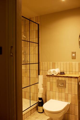 a bathroom with a toilet and a shower at The Wheatsheaf Combe Hay in Bath