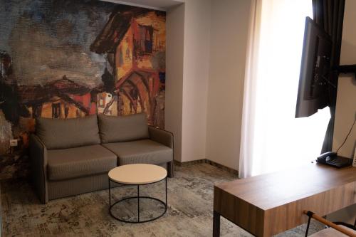 a living room with a couch and a table at Clepsydra Residence in Plovdiv