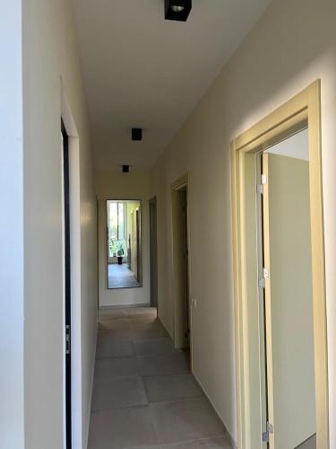 a hallway of a building with a door and a mirror at Best place in gonio in Gonio