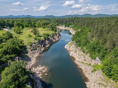 an aerial view of a river in the mountains at River House Moon in Gospić
