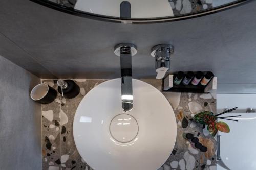 a bathroom with a white toilet in a room at De Bosset Suites Kefalonia in Argostoli