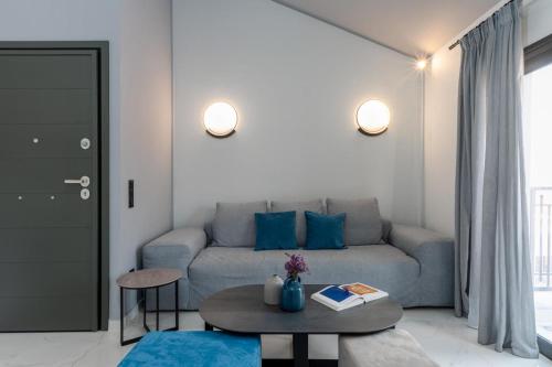 a living room with a couch and a table at De Bosset Suites Kefalonia in Argostoli