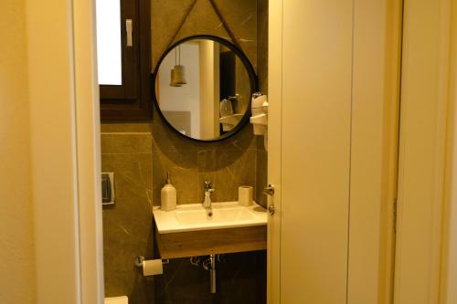 a bathroom with a sink and a mirror at BluMango Resort in Ierissos