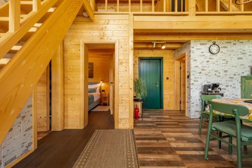 a wooden cabin with a bedroom and a bed at River House Moon in Gospić