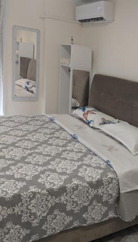 a bedroom with a large bed with a blanket at Emanuela Mystique in Kavala
