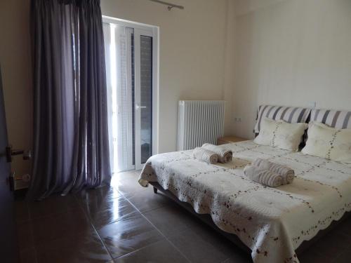Ένα ή περισσότερα κρεβάτια σε δωμάτιο στο Samaras Apartments in Kamena Vourla